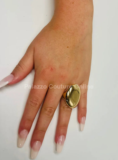 elegant gold statement ring, highlighting the bold, smooth design and sophisticated look.