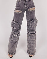 Make a bold fashion statement in these high-rise acid black wash denim jeans with rhinestone fringe detailing