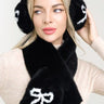front view of black fluffy winter scarf and bow ear muff set