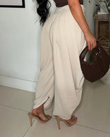 Chic Draped Pleated Pants - Beige side view showing jeans leg shape and fit