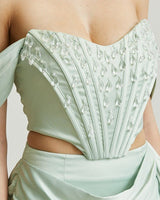 Side view of satin corset and ruched skirt set