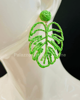 Green statement earrings with tropical leaf design