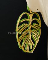 Green statement earrings with tropical leaf design