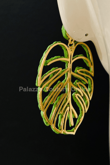 Green statement earrings with tropical leaf design