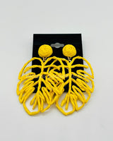 Yellow statement earrings with tropical leaf design