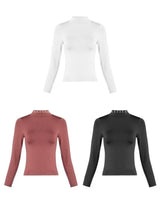 white long sleeve top styled on model
