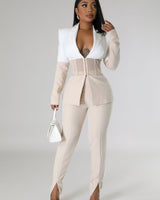 Close‐up of two piece pant set showing blazer detail and high‑waisted pants