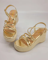 Side view of gold wedge sandals with 3.5-inch heel