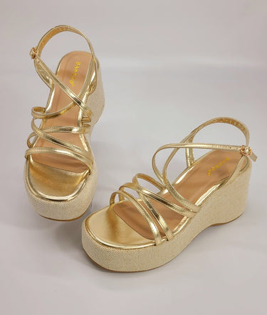 Side view of gold wedge sandals with 3.5-inch heel