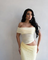 Elegant Butter off-shoulder maxi dress on model styled for evening event