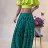 Green wide leg palazzo pants with allover Vogue-inspired graphic design