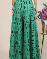 Printed palazzo pants in green with wide waistband and flowing legs