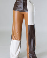 Close‑up of wide leg faux leather cargo pants showing faux leather texture and pocket detail
