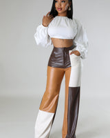 Back view of wide leg faux leather cargo pants – cargo pockets and straight leg silhouette