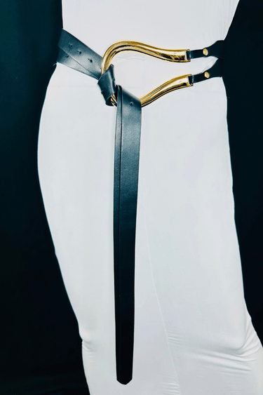 Black waist belt with curved gold metal accent and adjustable fit