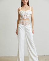 Rose-trimmed bustier and high-waisted white pants set