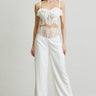 Rose-trimmed bustier and high-waisted white pants set