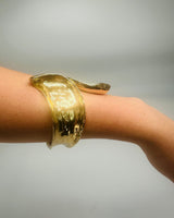 Close-up of gold Leaf Luxe Cuff Bangle jewelry piece