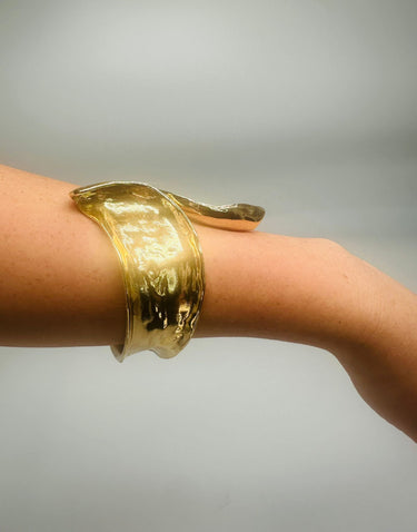 Close-up of gold Leaf Luxe Cuff Bangle jewelry piece