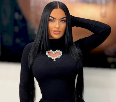 Long sleeve black knit top with stretch and heart detail