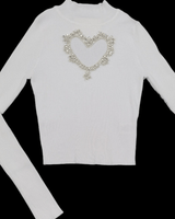 Ribbed white turtleneck with bold heart-shaped detail