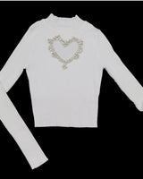 white heart cutout turtleneck top made of soft acrylic and nylon fabric