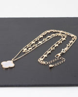 Clover necklace featuring polished gold finish and charm pendant