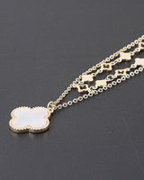 Gold cream clover necklace with layered chain design