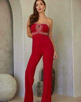 Elegant strapless jumpsuit with crystal embellishment – bold red design