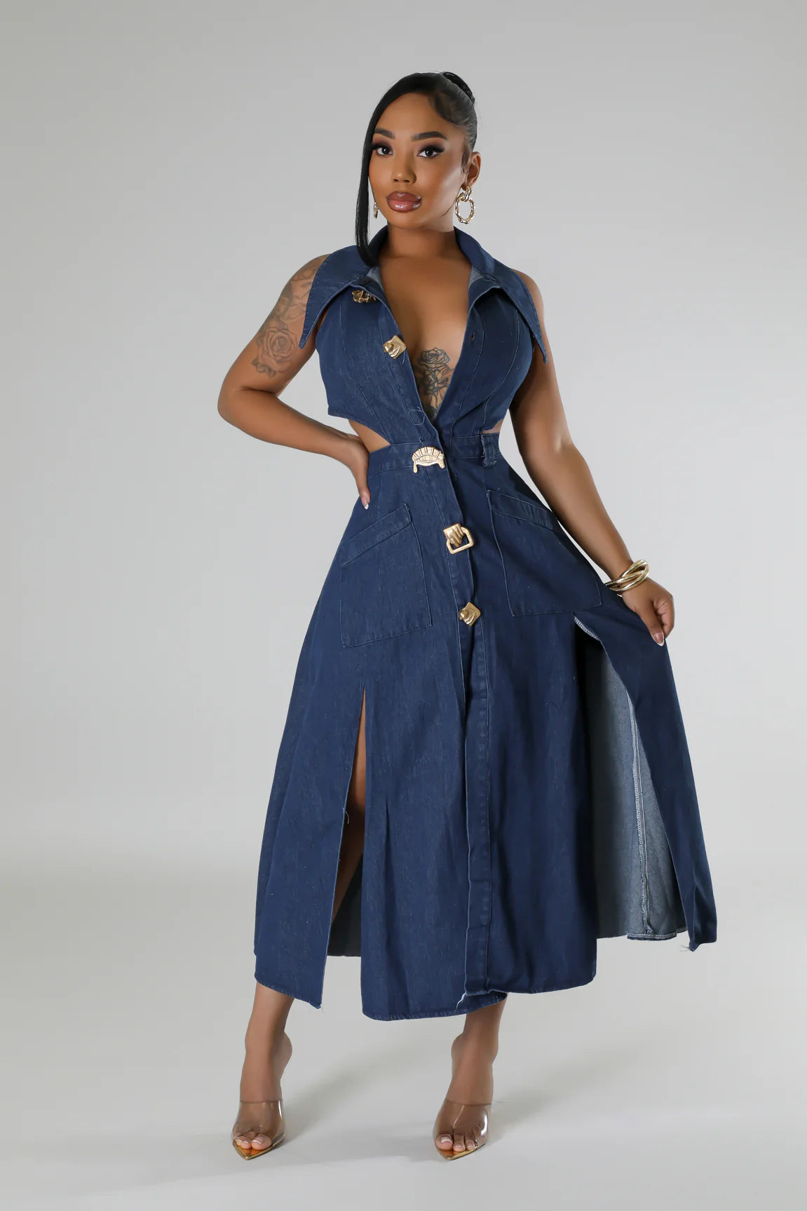 stylish denim maxi dress featuring a backless design and sleeveless cut, paired with gold heels.