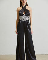 Black embellished halter jumpsuit with wide-leg pants and rhinestone waist