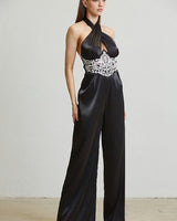 Elegant halter jumpsuit in black organza with golden waist embroidery