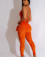 Flat lay of orange velvet mesh jumpsuit – one‑piece outfit with mesh accents
