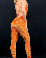 Close‑up of velvet mesh jumpsuit orange showing textured velvet and mesh detail