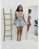 Stylish and trendy ribbed mini dress in cement, featuring a fitted bodice and a flared skirt for added style.