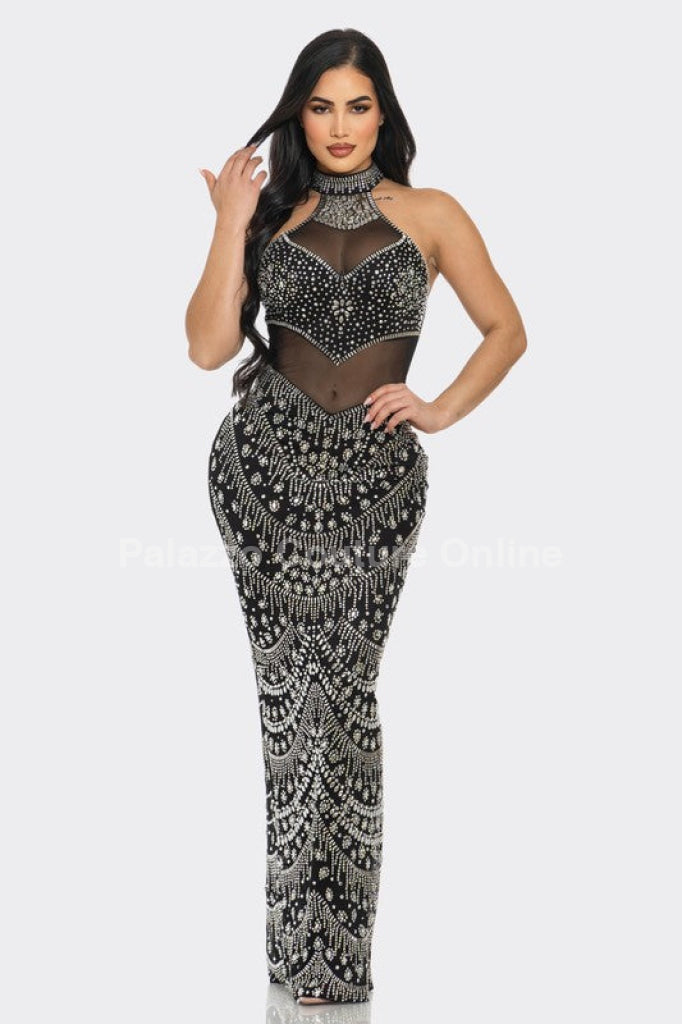 High-neck black dress with intricate rhinestone patterns and a dramatic look.
