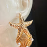 Dive deep into ocean-inspired elegance with these gold-plated starfish and pearl statement earrings.