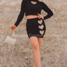 Black crop top and mini skirt co-ord with gold buttons