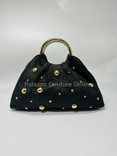 Black woven straw tote bag with gold accents and circular handles