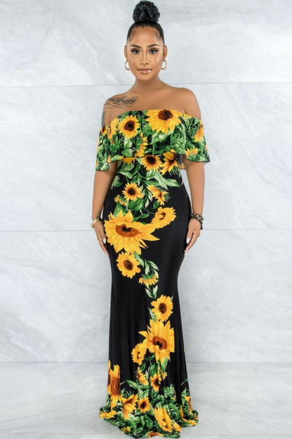 off-shoulder sunflower maxi dress with a vibrant floral print, featuring a fitted bodice and a flowing silhouette.