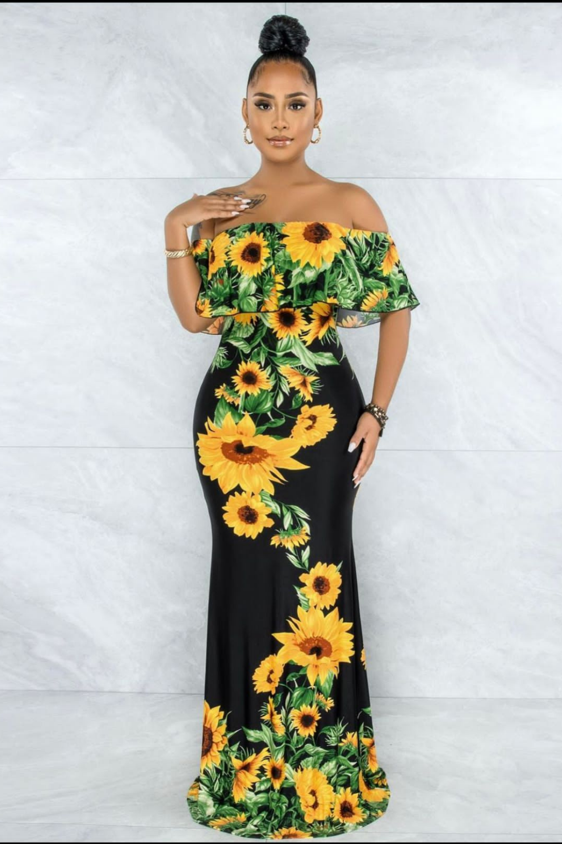 off-shoulder sunflower maxi dress highlighting the colorful sunflower print and elegant, flowing design.