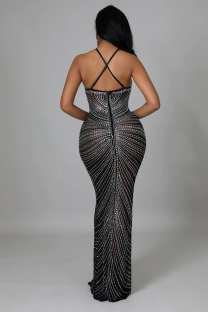 black rhinestone gown, highlighting the crisscross straps and fit.