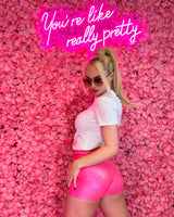 Metallic pink high-rise shorts, adding a touch of glam to any outfit.