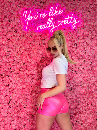 Metallic pink high-rise shorts, adding a touch of glam to any outfit.