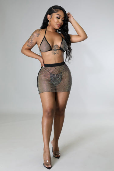Close‑up of black two piece skirt set showing rhinestone fishnet skirt and triangle top
